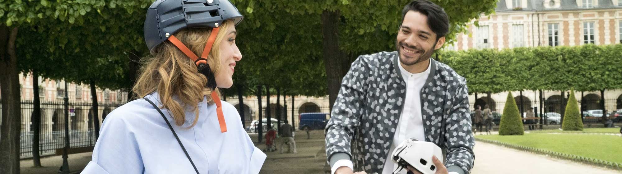 personnes à vélo et portant un casque, passant un bon moment sur la place des Vosges