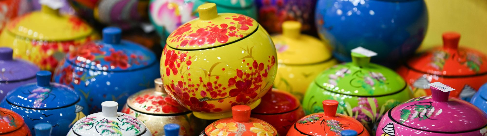 Pots en céramique colorés peints à la main exposés à World in Paris