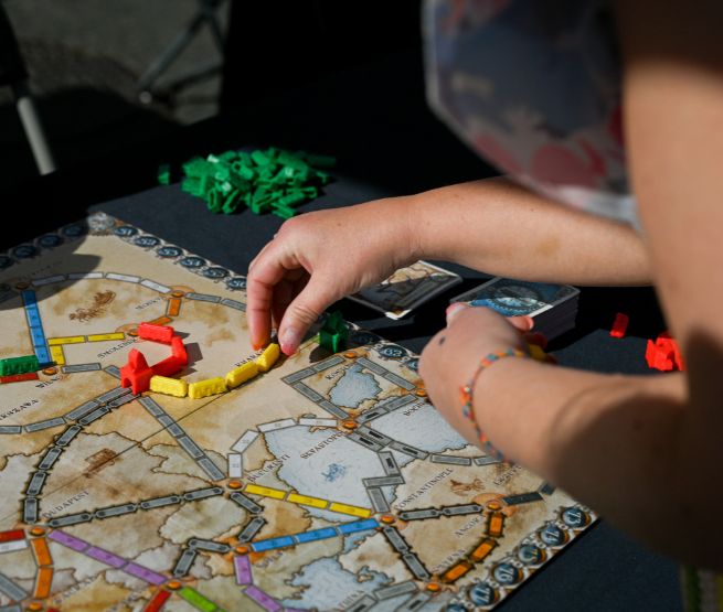 Animation ludique : partie de jeu de société ‘Les Aventuriers du Rail’ avec placement de wagons sur une carte de l’Europe